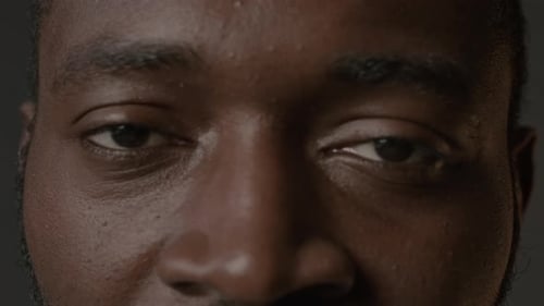 Extreme Close Up of Black Man Looking at Camera