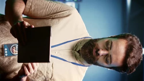 Man Works on Tablet in Modern Office