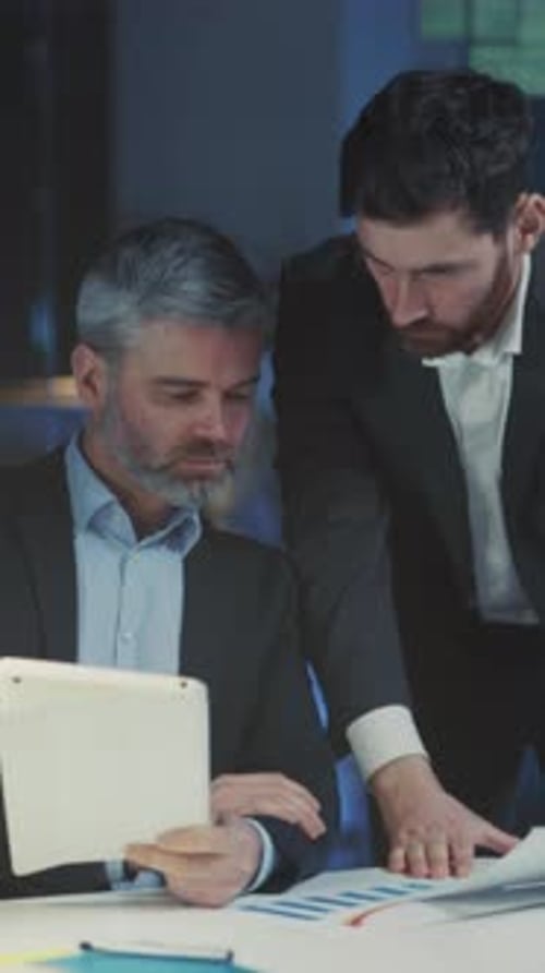 Executives Examine Charts and Discuss Strategies Managers Analyze Graphs and Make Investment
