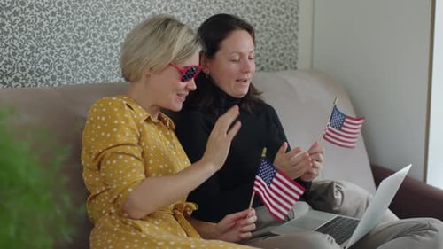 Women Celebrate with American Flags on Video Call