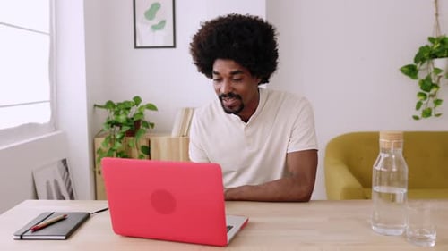 Enthusiastic Young Adult on Video Call at Home