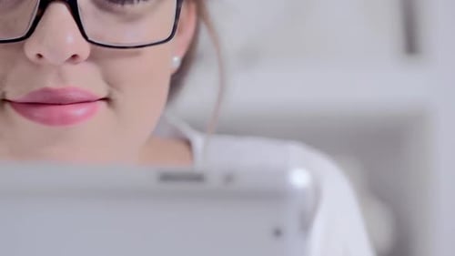 Attractive Young Blonde Woman Using Tablet Computer Touchscreen