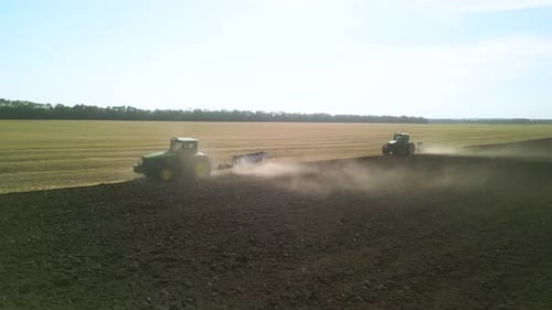 Tractors plowing the field in Ukraine