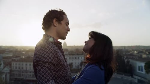 Romantic italian couple embracing with love overlooking Rome Italy from balcony