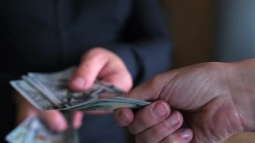 Close Up of Person Handing Money