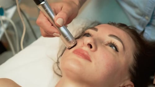 Woman Receiving Facial Treatment in Spa