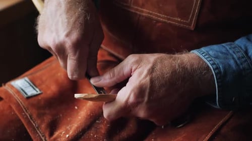Close up of Artisan Craftsman Carving Wooden Spoon
