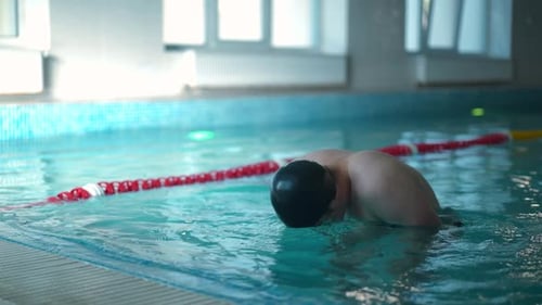 Young Caucasian Sportsman Washing Face with Swimming Pool Water in Slow Motion