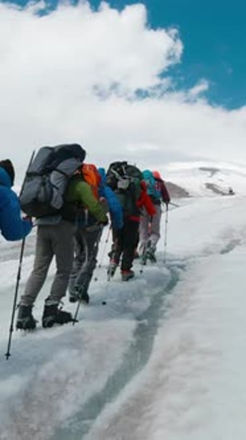 Climbers Climb Snowy Mountain Clip Climbers Follow Each Other in Line to Snowy Peak on Clear Day