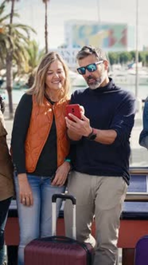 Tourist Couple Sharing Media on Online Cell Phone App in the City Looking for Directions