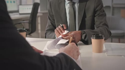 Unrecognizable Businessmen Signing Contract in Office