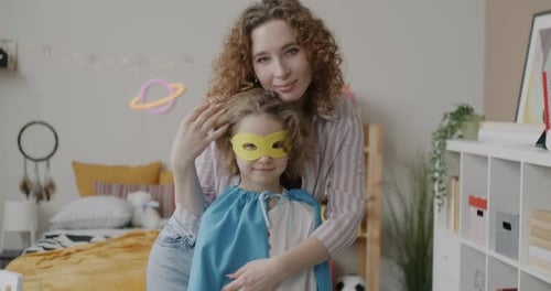 Woman and Child Play Superhero in Bedroom