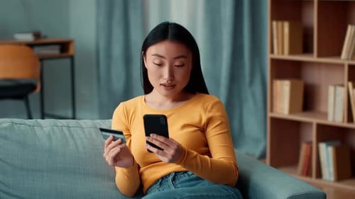 Woman Shops Online Using Phone and Credit Card