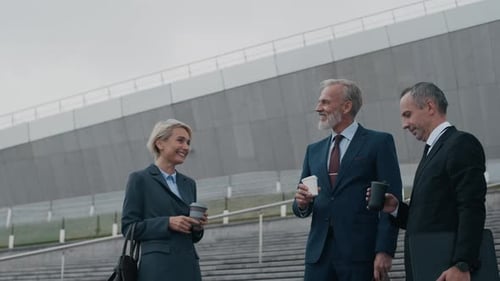 Middle-aged Entrepreneurs Drinking Coffee in Financial City District