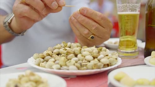 Eating Cooked Snails, Escargot From Plate, delicious Portuguese food.