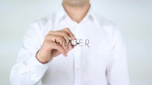 Person Writing Winter on Clear Surface with Marker