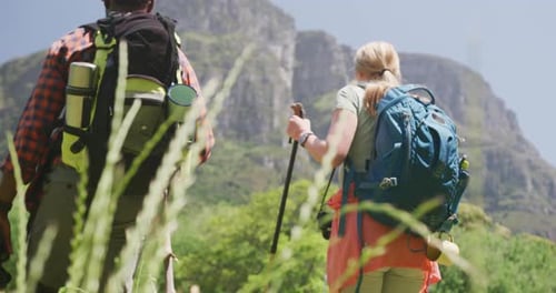 Couple Hiking in the Mountains on Summer Day