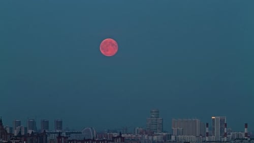 Moonrise time lapse over the illuminated moscow Russia skyline at twilight