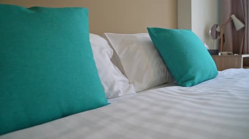 Crisp Linens and Pillows on Hotel Bed