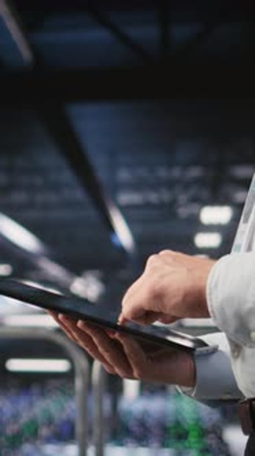 Vertical Video Close Up of Server Room Worker Checking Code on Tablet Next to Colleague