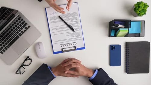 Business Meeting Reviewing Contracts and Analyzing Data