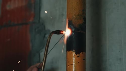 Gas Welding Steel Pipe During Industrial Installation Work