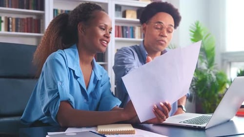 Team Reviewing Documents Together in a Home Office