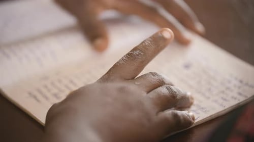 Close up footage of hands on a journal.
