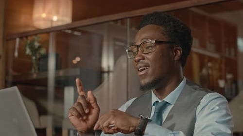 Young Adult Man Video Conferencing in Office Setting