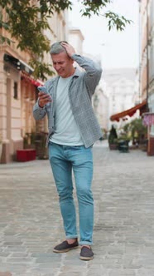 Mature Man Using Smartphone Typing Browsing Loses Becoming Shocked Sudden Lottery Results on Street