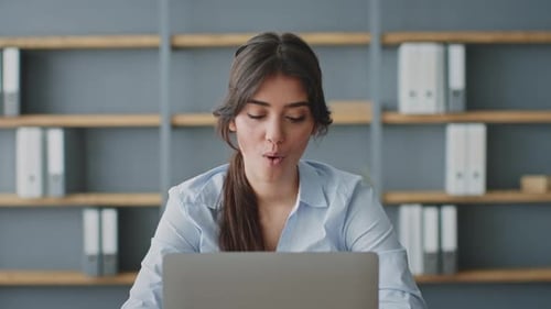 Young Woman Conducting an Online Lesson at Home with a Laptop