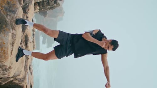 Professional Athlete Punch Air Seaside Cliff Vertical Boxer Training on Rocks