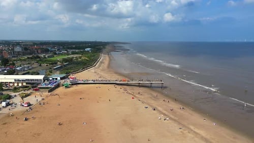 Skegness pier, Lincolnshire UK. Moving away from the pier to show golden sands of the beach.