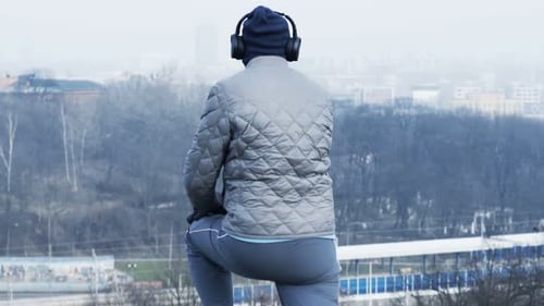 Male Jogger Stretching Legs and Start Jogging in City Park Active