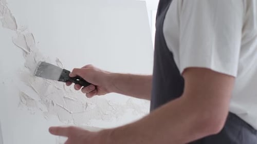 A Male Artist Works on Painting a Picture in a Creative Studio Creates an Abstract Painting Bright