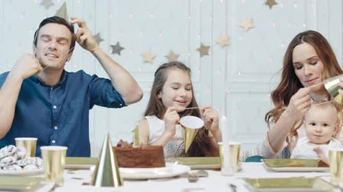 Happy Family Celebrating Birthday Party at Home