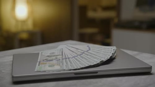 Money On Laptop In Contemporary Setting