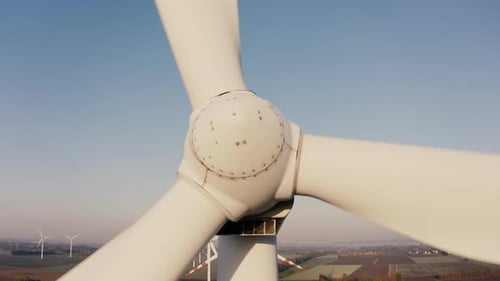 Cinematic Drone View of a Wind Farm During Sunrise in the Countryside