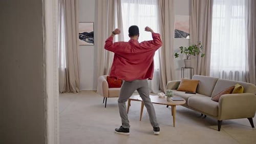 Young Man Dancer Performing Contemporary Dance Moving to Music From One Corner of Home to Another