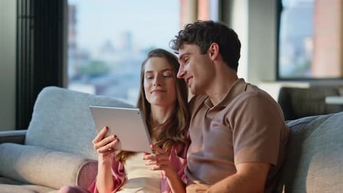 Married Couple Looking Tablet Sitting Sofa Cozy Home Closeup Smiling Man