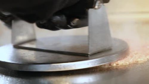 Close-Up of Smashing Beef Patty on Hot Grill