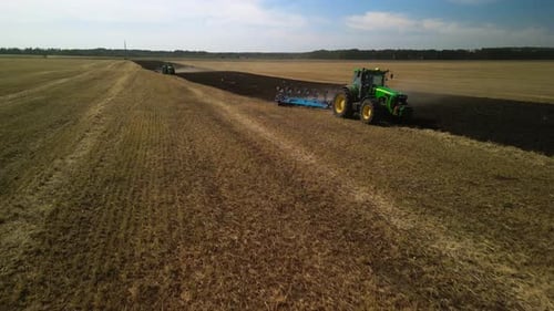 Tractors plowing the field in Ukraine