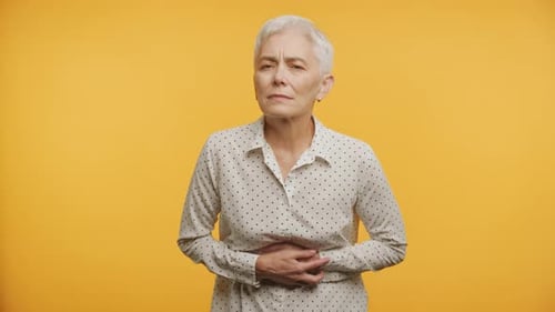 Senior Woman Suffering From Abdominal Pain