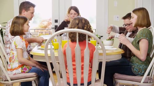 Family Enjoys Mealtime Together at Dining Table
