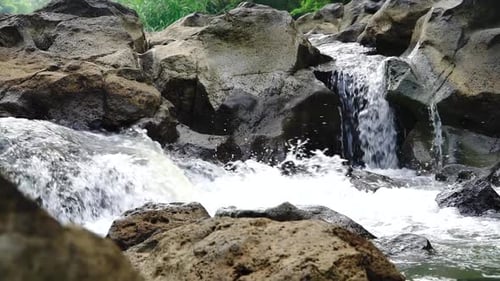 Water river courses through the rock. Clear water stream glides over rocks. Close up shot of a casca