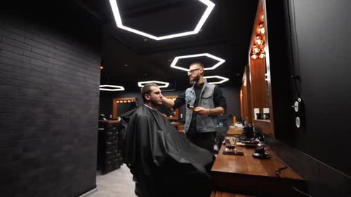 Barber Trimming Hair in Stylish Barbershop
