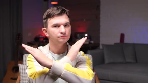 Young Adult Crossing Arms, Shaking Head in Disapproval