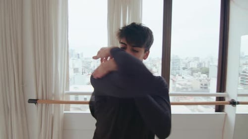 Young Adult Practicing Ballet in an Urban Studio