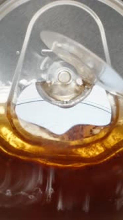 View inside a metal can of cola, cola pouring into a glass with ice, Vertical, Social Media