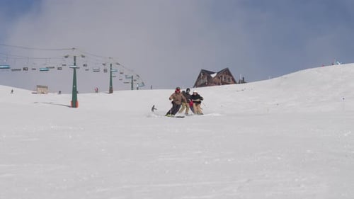 Skiers Skiing Downhill Together On Slope